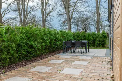 a table and chairs sitting on a brick patio at Rekerlanden 260 in Schoorldam
