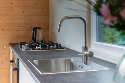 a kitchen with a sink and a stove at Rekerlanden 260 in Schoorldam