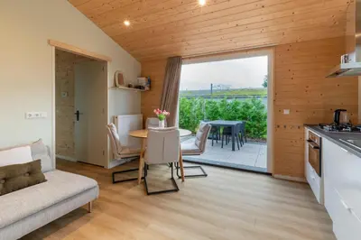 a kitchen and living room with a couch and a table at Rekerlanden 260 in Schoorldam