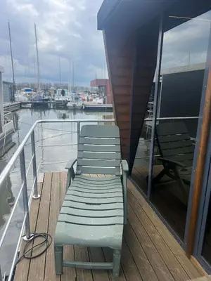 a bench sitting on the deck of a boat at Winter escape at houseboat Sanches Lake View Monnickendam in Monnickendam