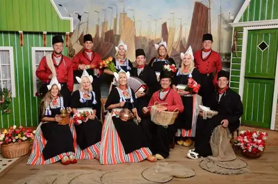 a group of people posing for a picture in front of a painting at Winter escape at houseboat Sanches Lake View Monnickendam in Monnickendam