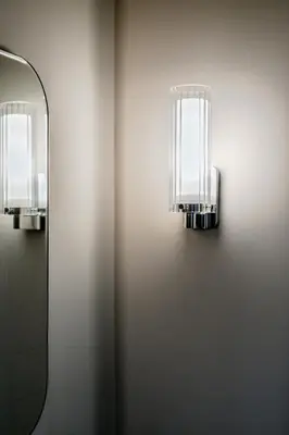two lights on a wall next to a mirror at Metzlr House in Haarlem