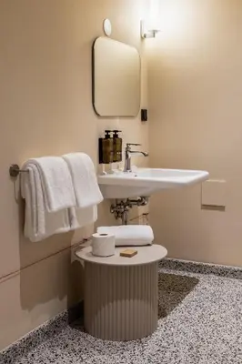 a bathroom with a sink and a mirror and towels at Metzlr House in Haarlem