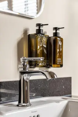 a sink with two soap dispensers on top of it at Metzlr House in Haarlem