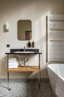 a bathroom with a sink and a tub and a mirror at Metzlr House in Haarlem