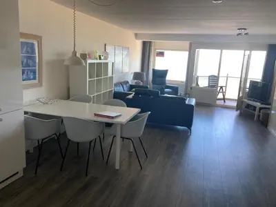 a living room with a table and chairs and a couch at Zonnehoek 71 in Egmond aan Zee
