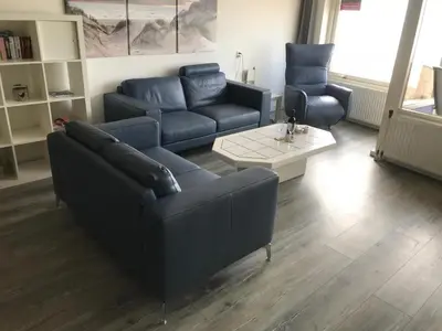 a living room with a couch and a table at Zonnehoek 71 in Egmond aan Zee