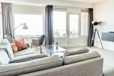 a living room with two couches and a table at Zonnehoek 75 in Egmond aan Zee