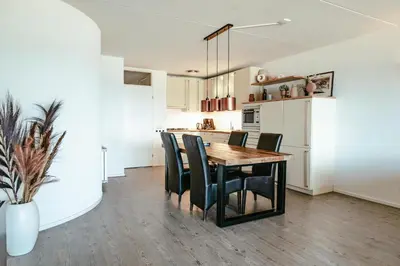 a kitchen and dining room with a table and chairs at Zonnehoek 75 in Egmond aan Zee