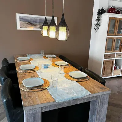 a dining room table with plates and glasses on it at The Lighthouse in Egmond aan Zee