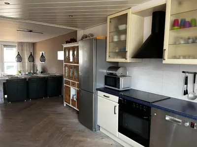 a kitchen with a refrigerator and a counter top at The Lighthouse in Egmond aan Zee