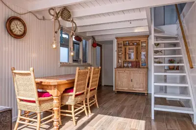 a dining room with a wooden table and chairs at Fay in Egmond aan Zee