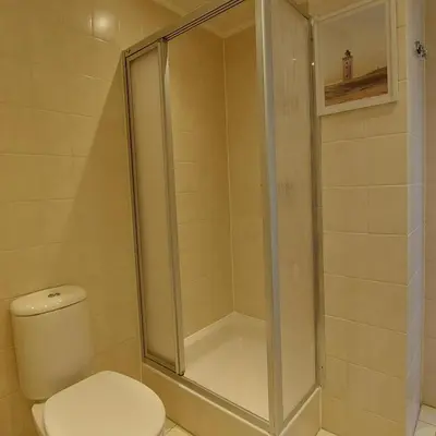 a shower stall in a bathroom with a toilet at Atlantis 14c in Egmond aan Zee