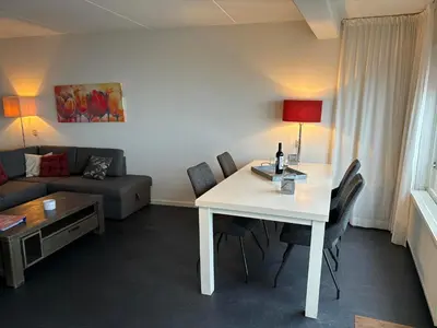 a living room with a white table and a couch at Zonnehoek 63 in Egmond aan Zee