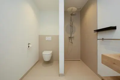 a bathroom with a toilet and a shower at Tulip Lodges in Voorhout