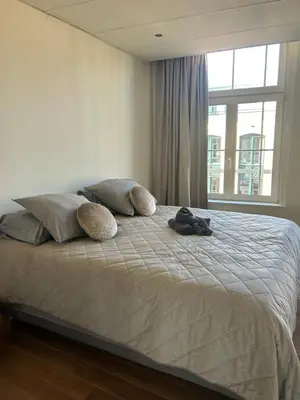 a bedroom with a bed with pillows and a window at Saya Loft in Amersfoort