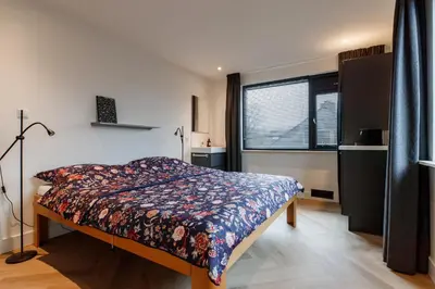 a bedroom with a bed and a window at Easy Sleep Lelystad in Lelystad