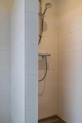 a shower with a glass door in a bathroom at Easy Sleep Lelystad in Lelystad