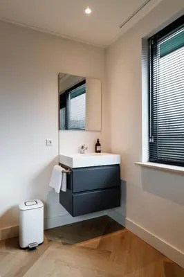 a bathroom with a sink and a mirror at Easy Sleep Lelystad in Lelystad