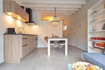 a kitchen with a table and chairs in a room at Cosea Beach House in Zandvoort