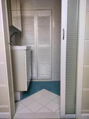 a small bathroom with a sink and a door at Vroonenburch in Burgerbrug