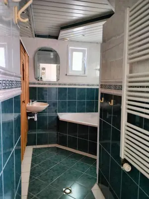 a bathroom with a tub and a sink and a mirror at Vroonenburch in Burgerbrug