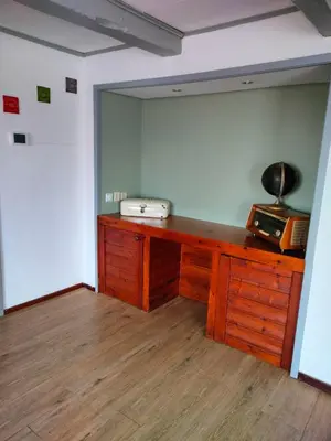 a room with a wooden desk with a microwave on it at Vroonenburch in Burgerbrug