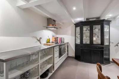 a kitchen with a counter and a black cabinet at Gwendolynn lovely holiday home in Bergen