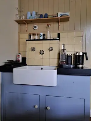 a kitchen with a white sink on a counter at Logies Reederij de IJsel in Gouda