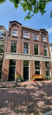 a brick building with a sign in front of it at Logies Reederij de IJsel in Gouda