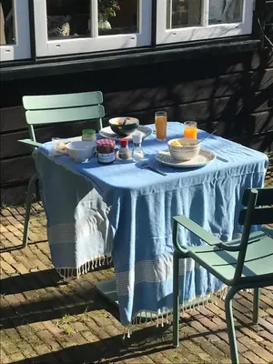 a table with a blue table cloth on it with food on it at t Ateliertje Noort in Bergen