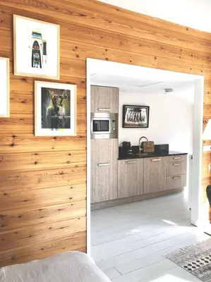 a room with a kitchen with wooden walls at t Ateliertje Noort in Bergen