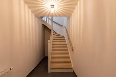 a staircase in a building with a light on the ceiling at Luxe 3-kamer Penthouse met dakterras in het centrum van Hoorn in Hoorn