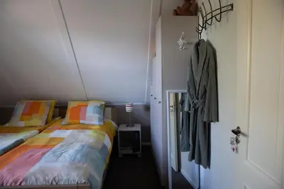 a bedroom with two beds and a hallway with a door at Bed and breakfast Hoeve Spoorzicht in Papekop