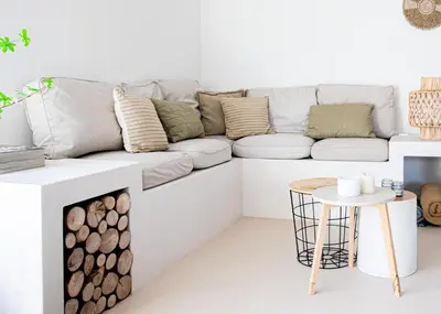 a white living room with a couch and a table at By Tons Huisje inclusief twee fietsen in Zegveld