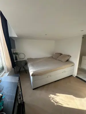 a small bedroom with a bed and a desk at WaalPlaat's B&B in Amsterdam