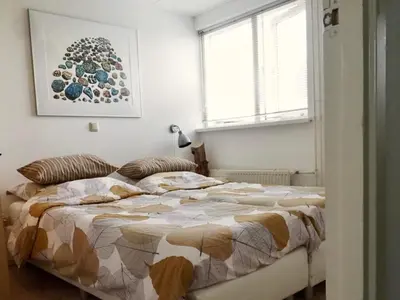a bedroom with a large bed in a room at Vakantiehuis Camperduin in Schoorl