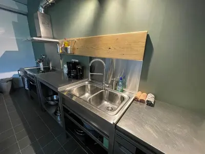 a kitchen with a sink and a counter top at Group accommodation Huize Blokland on nature farm - 14p in Hem