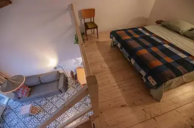 an overhead view of a bedroom with a bed and a chair at Group accommodation Huize Blokland on nature farm - 14p in Hem