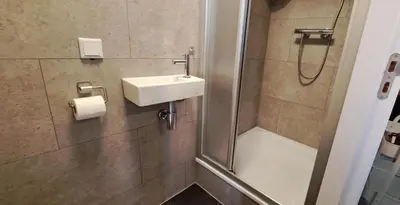 a bathroom with a sink and a shower at Guesthouse Purmerend near Amsterdam Volendam in Purmerend
