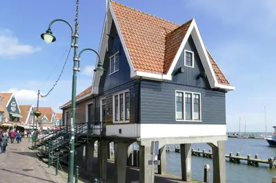 a house on a dock next to the water at Guesthouse Purmerend near Amsterdam Volendam in Purmerend