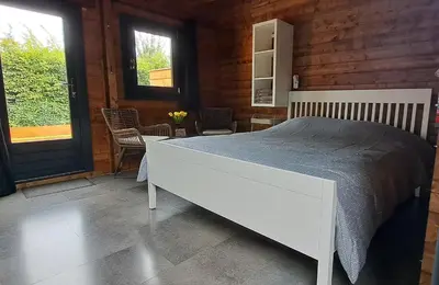 a bedroom with a large white bed in a room at Guesthouse Purmerend near Amsterdam Volendam in Purmerend