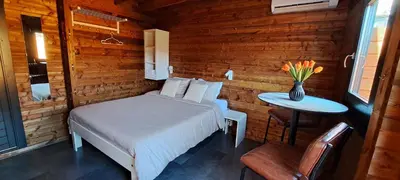 a bedroom with a bed and a table with a vase of flowers at Guesthouse Purmerend near Amsterdam Volendam in Purmerend