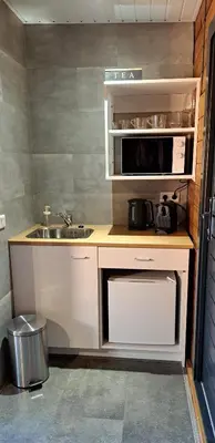 a small kitchen with a sink and a microwave at Guesthouse Purmerend near Amsterdam Volendam in Purmerend