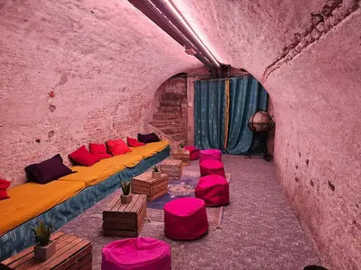 a room with beds and chairs in a pink wall at Overnachten aan de Werf in Utrecht