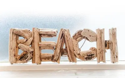 a word made out of wood on a wall at Beachstudio in Zandvoort
