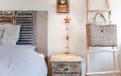 a bedroom with a bed and a ladder and a table at Beachstudio in Zandvoort