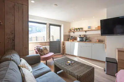 a living room with a couch and a table at Beachstudio in Zandvoort