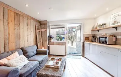 a living room with a couch and a kitchen at Beachstudio in Zandvoort
