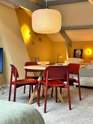 a room with a table and chairs and a bed at Familielogement De Oude Beltoren in Utrecht